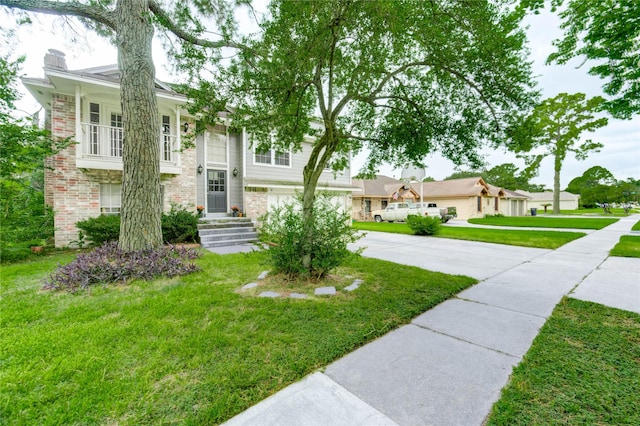 15403 Meadow Village Dr, Houston, TX 77095 - view of front of house with driveway, a chimney, brick siding, a front yard, and a garage