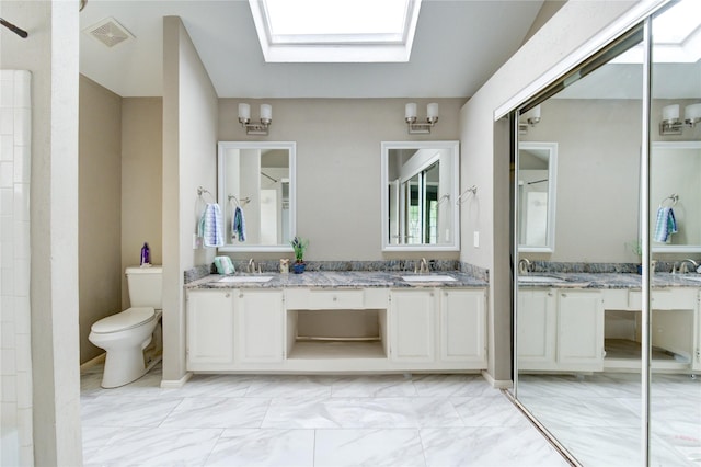 15403 Meadow Village Dr, Houston, TX 77095 - bathroom featuring double vanity, a skylight, marble look tiles, and a shower