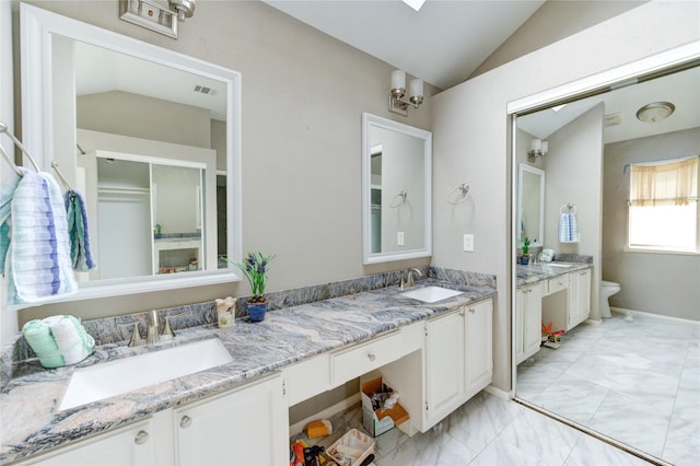15403 Meadow Village Dr, Houston, TX 77095 - full bathroom featuring vaulted ceiling, double vanity, and marble look tile flooring