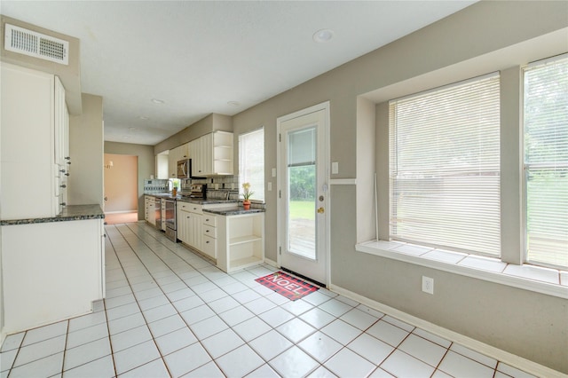 15403 Meadow Village Dr, Houston, TX 77095 - kitchen with open shelves, stainless steel appliances, white cabinets, and healthy amount of natural light