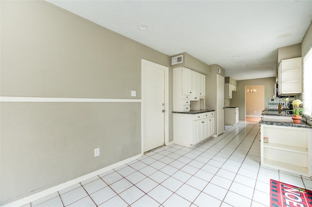 15403 Meadow Village Dr, Houston, TX 77095 - kitchen featuring dark countertops, open shelves, white cabinetry, and light tile patterned floors