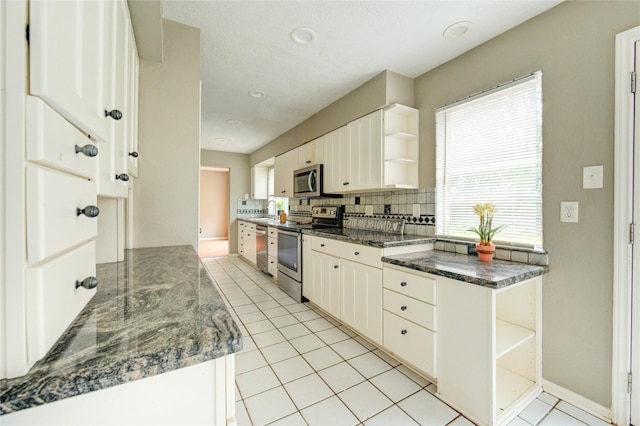 15403 Meadow Village Dr, Houston, TX 77095 - kitchen featuring stainless steel appliances, open shelves, tasteful backsplash, light tile patterned floors, and white cabinetry