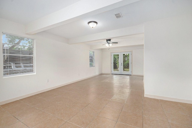 1605 30th St N, Texas City, TX 77590 - spare room with beamed ceiling, french doors, light tile patterned floors, and ceiling fan