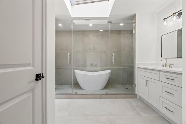 1009 Genova St, Houston, TX 77009 - full bathroom featuring vanity, tile patterned flooring, a freestanding tub, a stall shower, and recessed lighting