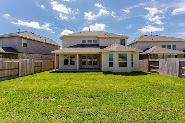 8506 Belfast Manor Ln, Richmond, TX 77407 - back of house with a fenced backyard and a shingled roof