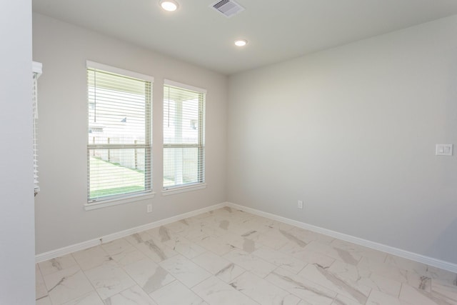 8506 Belfast Manor Ln, Richmond, TX 77407 - empty room featuring healthy amount of natural light, light marble finish flooring, and recessed lighting