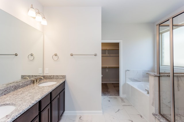 8506 Belfast Manor Ln, Richmond, TX 77407 - full bath with marble look tiles, a garden tub, double vanity, a walk in closet, and a shower