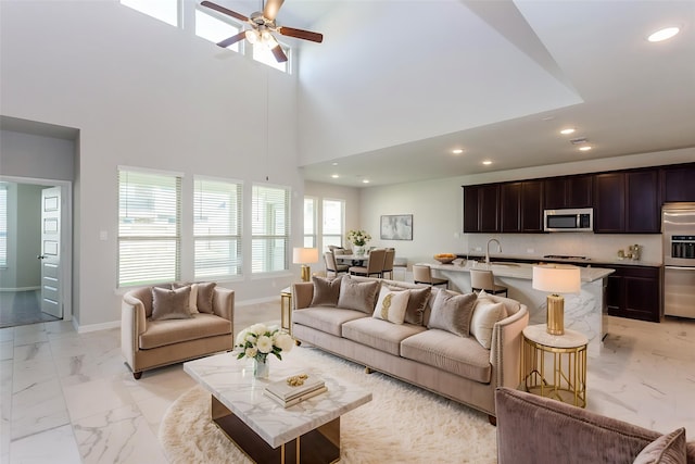 8506 Belfast Manor Ln, Richmond, TX 77407 - living room featuring light marble finish floors, recessed lighting, a ceiling fan, and a high ceiling