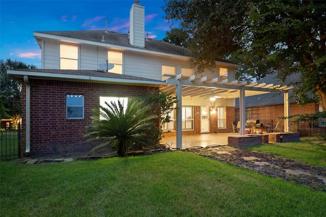 8014 Sports Haven Dr, Humble, TX 77346 - back of house at dusk with brick siding, a pergola, a chimney, and a patio area