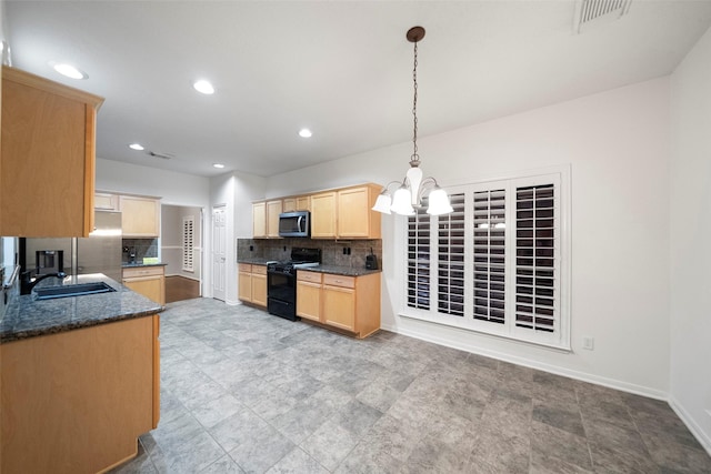 8014 Sports Haven Dr, Humble, TX 77346 - kitchen featuring black gas range oven, stainless steel microwave, light brown cabinetry, backsplash, and pendant lighting