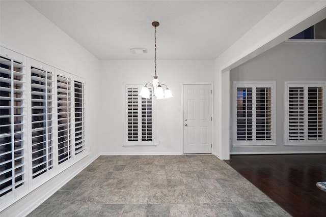 8014 Sports Haven Dr, Humble, TX 77346 - unfurnished dining area featuring a chandelier and stone finish flooring