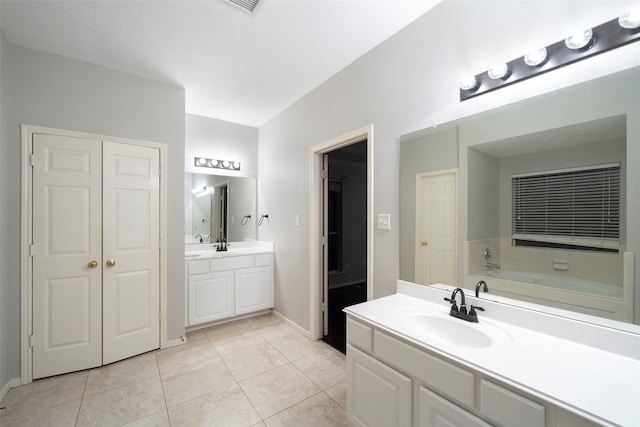 8014 Sports Haven Dr, Humble, TX 77346 - bathroom with two vanities, a bath, and tile patterned floors