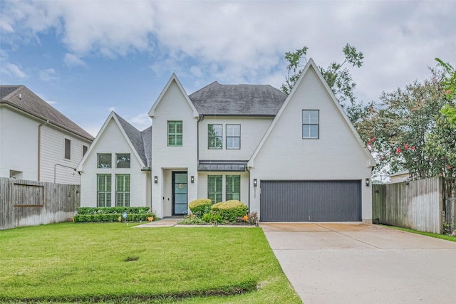 6525 Wharton St, Houston, TX 77055 - view of front facade featuring concrete driveway, an attached garage, a shingled roof, stucco siding, and a standing seam roof