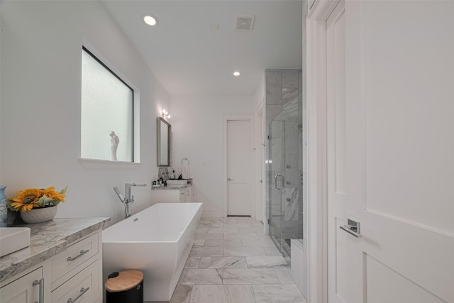 6525 Wharton St, Houston, TX 77055 - full bath with vanity, a stall shower, a freestanding tub, marble finish floors, and recessed lighting