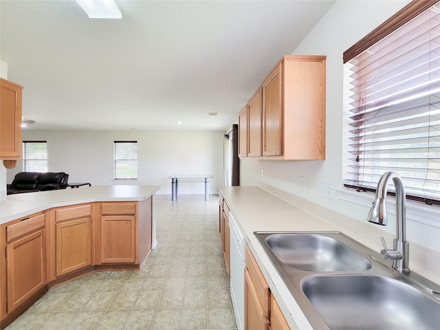 18403 Fair Grange Ln, Cypress, TX 77433 - kitchen with light countertops, a peninsula, light floors, and white dishwasher