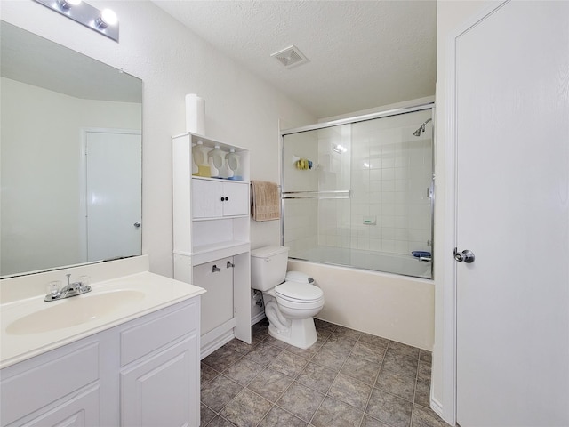 18403 Fair Grange Ln, Cypress, TX 77433 - bathroom with vanity, enclosed tub / shower combo, and a textured ceiling