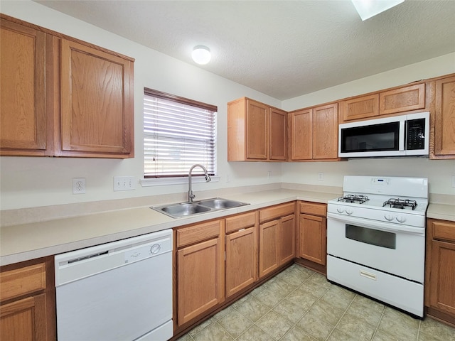 18403 Fair Grange Ln, Cypress, TX 77433 - kitchen with white appliances, light countertops, brown cabinets, and a textured ceiling