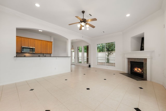 7615 Brae Acres Ct, Houston, TX 77074 - unfurnished living room with crown molding, ceiling fan, a fireplace, recessed lighting, and arched walkways