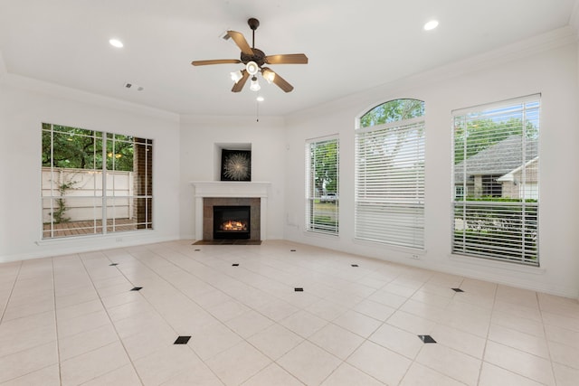 7615 Brae Acres Ct, Houston, TX 77074 - unfurnished living room with healthy amount of natural light, ornamental molding, ceiling fan, a tiled fireplace, and tile patterned flooring