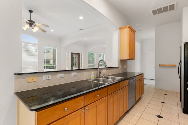 7615 Brae Acres Ct, Houston, TX 77074 - kitchen featuring appliances with stainless steel finishes, tasteful backsplash, ceiling fan, arched walkways, and recessed lighting