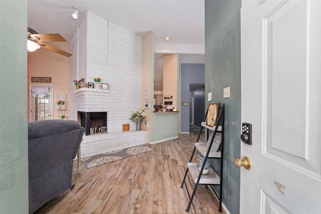 3060 High Plains Dr, Katy, TX 77449 - foyer with ceiling fan, wood finished floors, and a brick fireplace