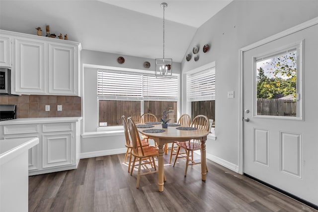 3731 Crescent Dr, Pearland, TX 77584 - dining space with lofted ceiling, dark wood-type flooring, and a chandelier