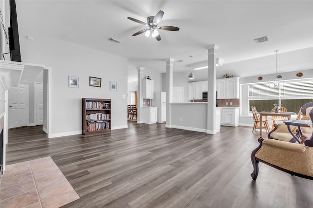 3731 Crescent Dr, Pearland, TX 77584 - living room featuring ornate columns, ceiling fan, dark wood-type flooring, and a towering ceiling