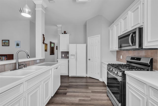 3731 Crescent Dr, Pearland, TX 77584 - kitchen featuring appliances with stainless steel finishes, light countertops, dark wood finished floors, decorative backsplash, and white cabinets