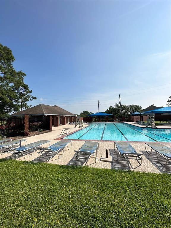 3731 Crescent Dr, Pearland, TX 77584 - community pool with a patio area and a yard