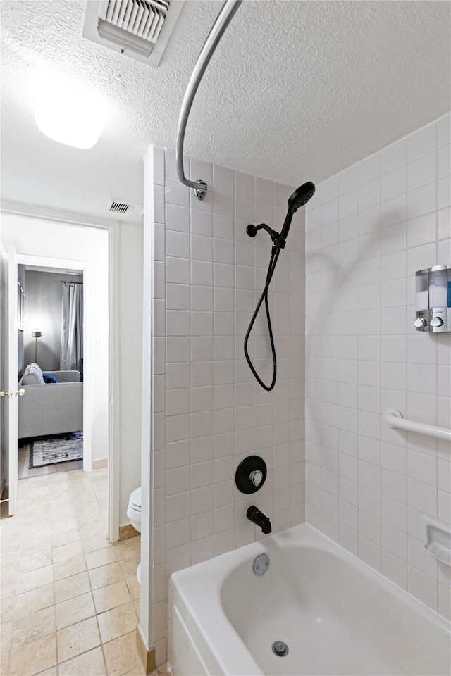 12900 Walden Rd Unit 706G, Montgomery, TX 77356 - bathroom featuring ensuite bathroom, bathtub / shower combination, a textured ceiling, and tile patterned floors