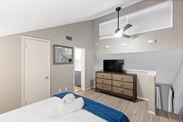 12900 Walden Rd Unit 706G, Montgomery, TX 77356 - bedroom with light wood-style flooring, a textured ceiling, ensuite bathroom, high vaulted ceiling, and a ceiling fan