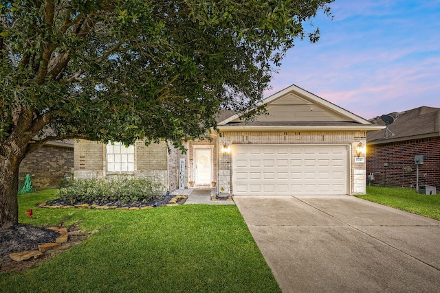15110 Sierra Ridge Dr, Humble, TX 77396 - ranch-style home featuring brick siding, concrete driveway, a lawn, and an attached garage