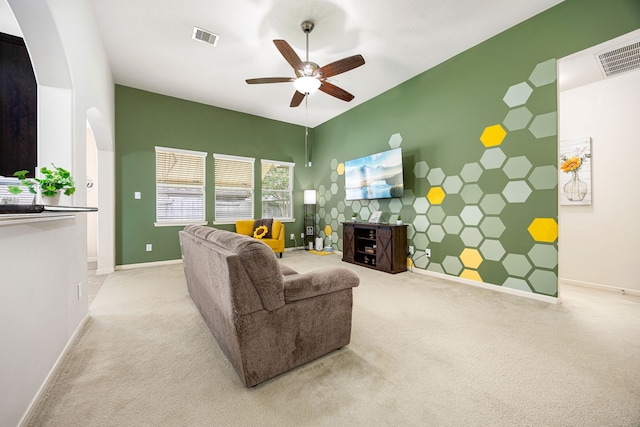 15110 Sierra Ridge Dr, Humble, TX 77396 - carpeted living area with ceiling fan, an accent wall, and arched walkways