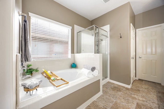 15110 Sierra Ridge Dr, Humble, TX 77396 - bathroom featuring a stall shower, a bath, and stone finish flooring