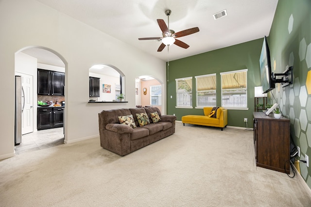 15110 Sierra Ridge Dr, Humble, TX 77396 - living area with light carpet, ceiling fan, and arched walkways