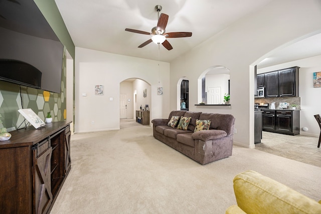 15110 Sierra Ridge Dr, Humble, TX 77396 - living room with light carpet, ceiling fan, and arched walkways