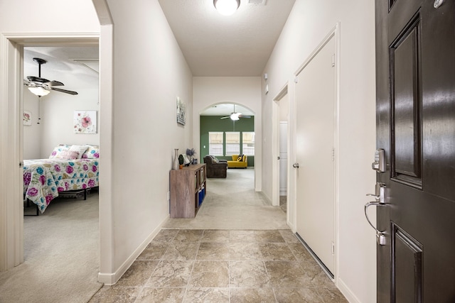 15110 Sierra Ridge Dr, Humble, TX 77396 - hallway featuring arched walkways, light carpet, and light stone finish floors