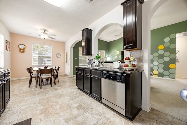 15110 Sierra Ridge Dr, Humble, TX 77396 - kitchen with stainless steel dishwasher, ceiling fan, arched walkways, and decorative backsplash