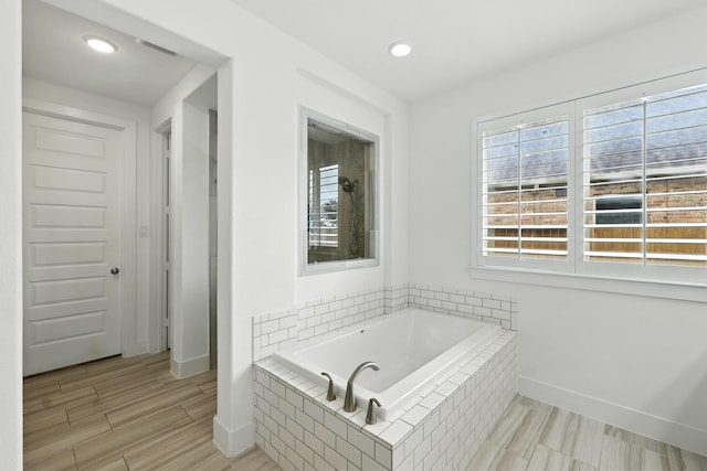 2607 Open Prairie Ln, Katy, TX 77493 - bathroom with a bath, wood finished floors, and recessed lighting
