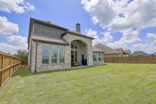 2607 Open Prairie Ln, Katy, TX 77493 - back of house featuring a chimney, a patio area, brick siding, and a fenced backyard