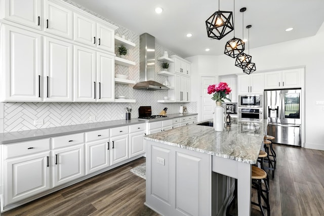 2607 Open Prairie Ln, Katy, TX 77493 - kitchen featuring stainless steel appliances, wall chimney range hood, open shelves, tasteful backsplash, and recessed lighting