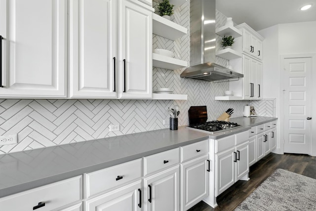 2607 Open Prairie Ln, Katy, TX 77493 - kitchen featuring open shelves, wall chimney range hood, stainless steel gas cooktop, decorative backsplash, and white cabinetry