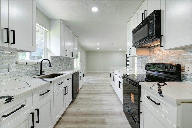 1221 Delores St, Kemah, TX 77565 - kitchen with black appliances, white cabinets, decorative backsplash, light stone counters, and recessed lighting