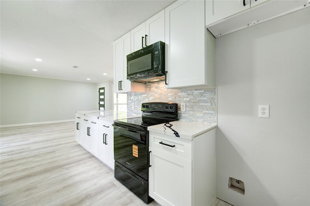 1221 Delores St, Kemah, TX 77565 - kitchen with black appliances, backsplash, light wood-style flooring, white cabinets, and recessed lighting