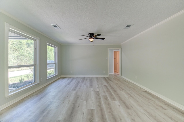 1221 Delores St, Kemah, TX 77565 - empty room featuring a textured ceiling, ornamental molding, ceiling fan, and light wood-style flooring