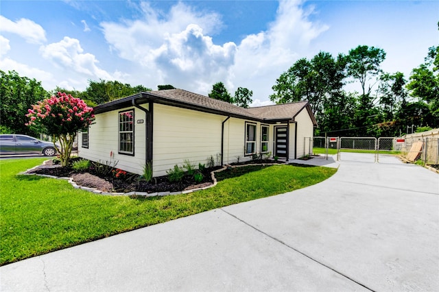1221 Delores St, Kemah, TX 77565 - view of front of property with driveway and a gate