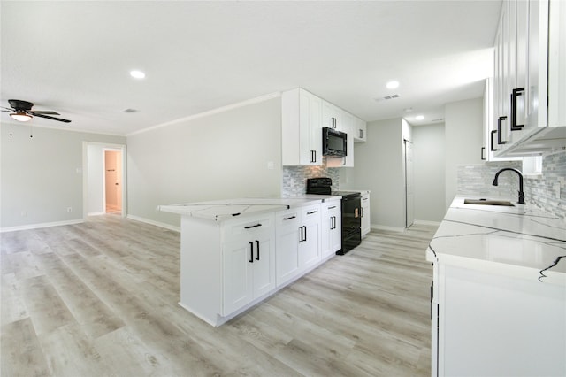 1221 Delores St, Kemah, TX 77565 - kitchen with black appliances, light stone countertops, tasteful backsplash, a ceiling fan, and recessed lighting