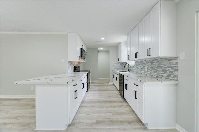1221 Delores St, Kemah, TX 77565 - kitchen with electric stove, light wood finished floors, a peninsula, backsplash, and black dishwasher