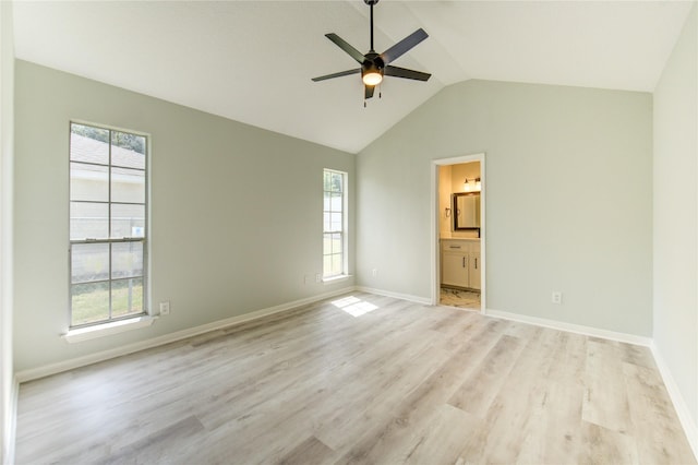 1221 Delores St, Kemah, TX 77565 - unfurnished bedroom featuring multiple windows, light wood-style floors, lofted ceiling, ensuite bath, and a ceiling fan