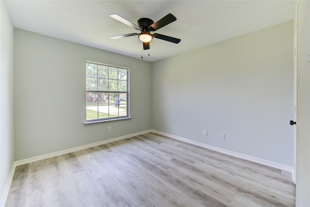 1221 Delores St, Kemah, TX 77565 - empty room featuring wood finished floors, a ceiling fan, and a textured ceiling
